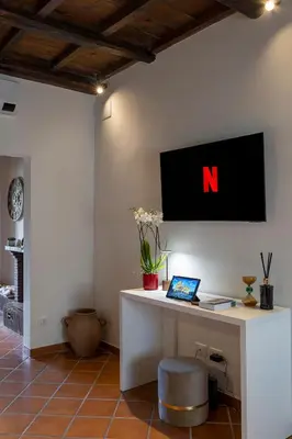 an office with a desk with a laptop on it at Views of the Coliseum in Rome
