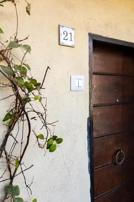 a house with a door and a clock on the wall at Views of the Coliseum in Rome