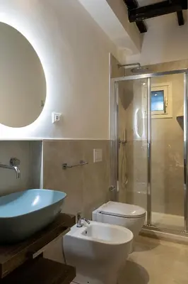 a bathroom with a sink and a toilet and a shower at Views of the Coliseum in Rome