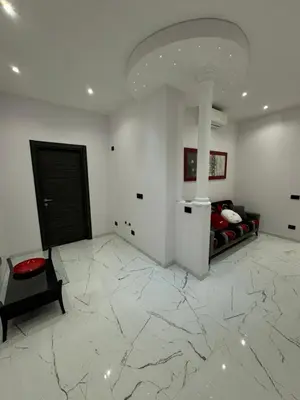 a bedroom with a bed in a room with marble floors at Heaven of Maya in Rome