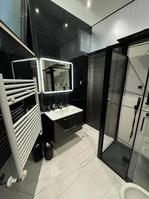 a black bathroom with a sink and a mirror at Heaven of Maya in Rome