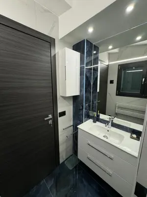 a bathroom with a sink and a black door at Heaven of Maya in Rome