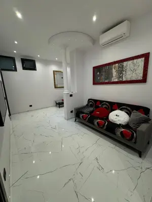 a living room with a couch on a marble floor at Heaven of Maya in Rome