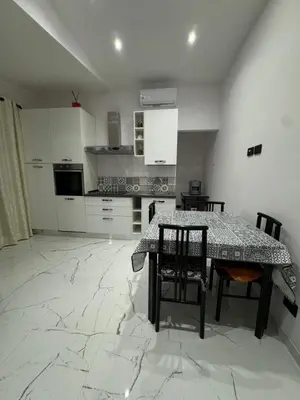 a kitchen with a table and chairs in a room at Heaven of Maya in Rome