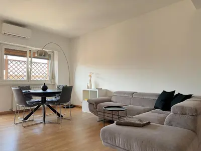 a living room with a couch and a table at Lumen House - Attico con Suite in Rome