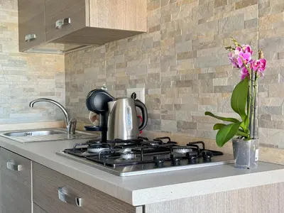 a tea kettle sitting on top of a stove in a kitchen at Lumen House - Attico con Suite in Rome