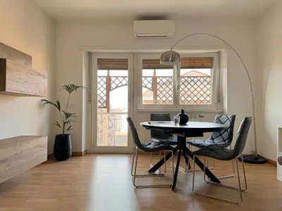 a dining room with a table and chairs at Lumen House - Attico con Suite in Rome