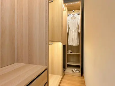 a dressing room with a shirt hanging on a closet at Lumen House - Attico con Suite in Rome