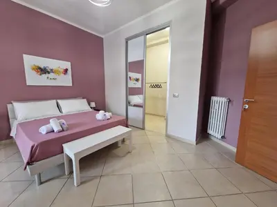 a bedroom with a bed with a bench and a mirror at GarbantSuite Apartment In Rome in Rome