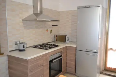 a kitchen with a stove and a white refrigerator at GarbantSuite Apartment In Rome in Rome