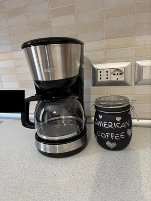 a coffee maker on a counter next to a can of coffee at GarbantSuite Apartment In Rome in Rome