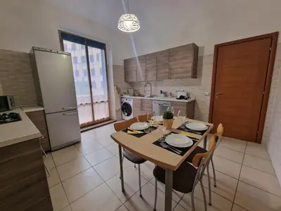 a kitchen with a table and chairs in a kitchen at GarbantSuite Apartment In Rome in Rome