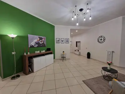 a living room with a green and white wall at GarbantSuite Apartment In Rome in Rome
