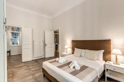 a bedroom with a large bed with towels on it at Nest House Prati in Rome