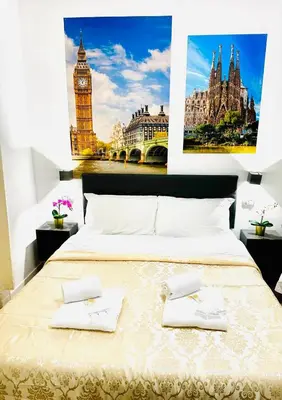a bedroom with a large bed with a large clock tower at Rome Holiday Guesthouse in Rome