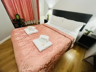 a bedroom with a bed with two towels on it at Rome Holiday Guesthouse in Rome