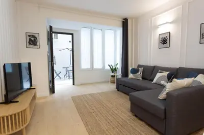 a living room with a couch and a television at Panti Guesthouse in Rome