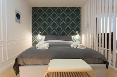 a bedroom with a large bed with two lights on it at Panti Guesthouse in Rome