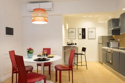 a kitchen with a table and chairs in a kitchen at Panti Guesthouse in Rome