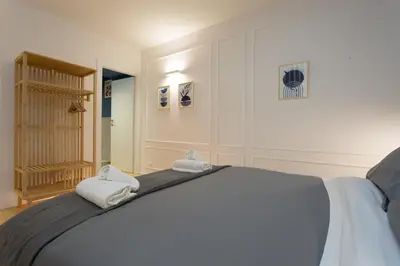a bedroom with a bed with towels on it at Panti Guesthouse in Rome