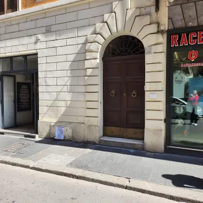 a building with a brown door on a street at Rooms house corso 22 in Rome