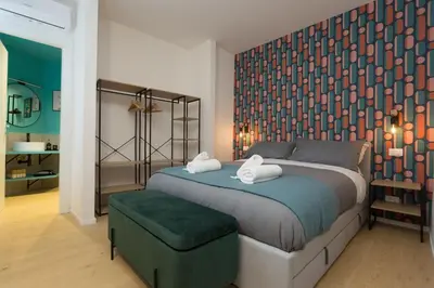 a bedroom with a bed with two towels on it at Filo Guesthouse in Rome