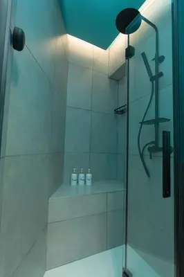 a bathroom with a shower with three bottles at Filo Guesthouse in Rome
