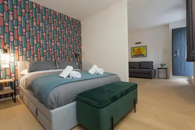 a bedroom with a bed and a living room at Filo Guesthouse in Rome