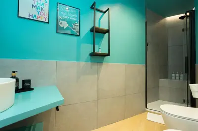 a bathroom with a shower and a toilet and a sink at Filo Guesthouse in Rome