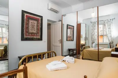 a room with two tables and two beds at Holidays Banchi Vecchi Apartment in Rome