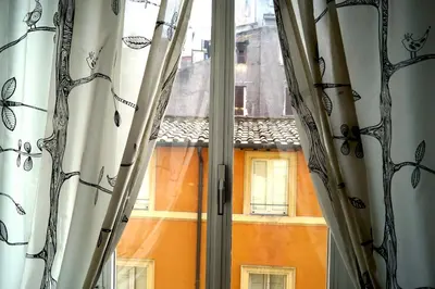 an open window with a view of a building at Holidays Banchi Vecchi Apartment in Rome