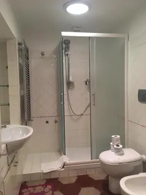 a bathroom with a shower and a toilet and a sink at Holidays Banchi Vecchi Apartment in Rome