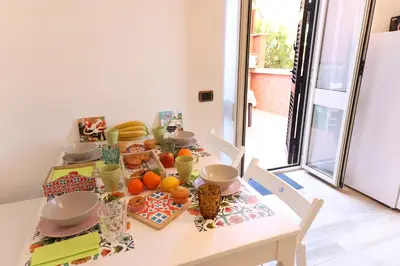 a dining room table with fruits and vegetables on it at Giulia's Vatican Apartment Saint Peter in Rome