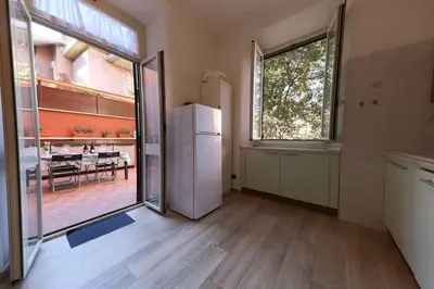a kitchen with a refrigerator and a dining room at Giulia's Vatican Apartment Saint Peter in Rome