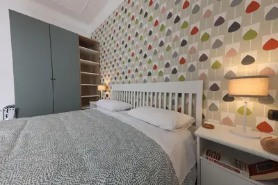 a bedroom with a bed and a wall with hearts at Giulia's Vatican Apartment Saint Peter in Rome