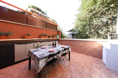 a small patio with a table on a balcony at Giulia's Vatican Apartment Saint Peter in Rome