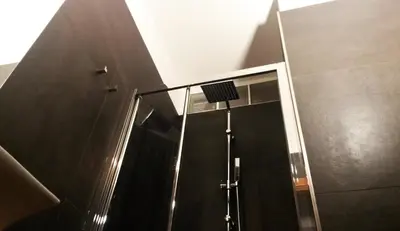 a shower with a glass door in a bathroom at LCH-Lateran Charming House in Rome