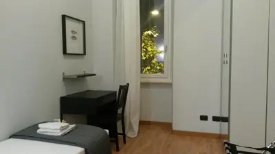 a room with a desk and a table and a window at LCH-Lateran Charming House in Rome