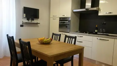 a kitchen with a wooden table with a bowl of fruit on it at LCH-Lateran Charming House in Rome