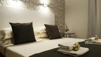 a bedroom with a bed with towels on it at LCH-Lateran Charming House in Rome
