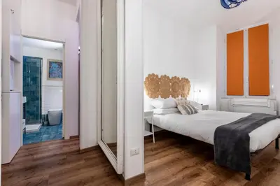 a white bedroom with a large bed and a mirror at Casa Crispi by Hili in Rome