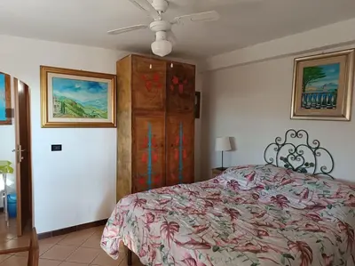 a bedroom with a bed and a dresser at Terrazza di Antonio in Rome