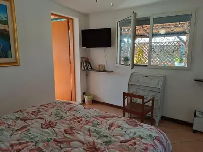 a bedroom with a bed and a chair and a window at Terrazza di Antonio in Rome