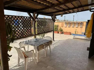 a patio with a table and chairs on a patio at Terrazza di Antonio in Rome