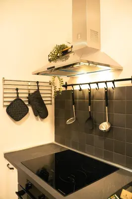 a kitchen with a sink and utensils on the wall at Casa Del Grande in Trastevere in Rome