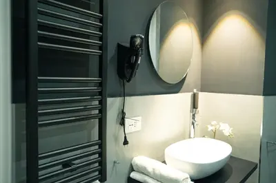 a bathroom with a sink and a mirror at Casa Del Grande in Trastevere in Rome