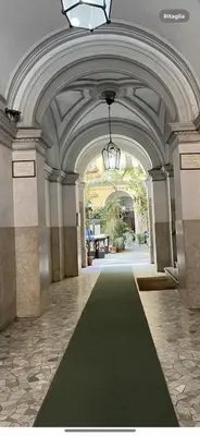 a large hallway with a black carpet in a building at Casa Del Grande in Trastevere in Rome