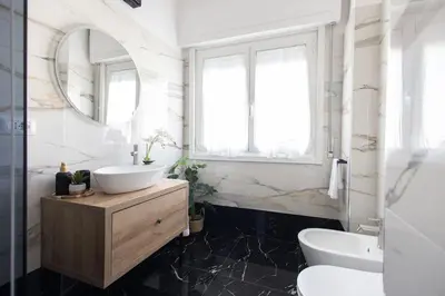 a bathroom with a sink and a mirror at City Vibe Red Rose in Rome