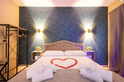 a bedroom with a bed with a heart on it at City Vibe Red Rose in Rome