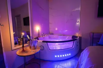 a bathroom with a tub with purple lights in it at City Vibe Red Rose in Rome
